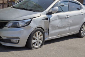 A car with a damaged driver door after an accident.