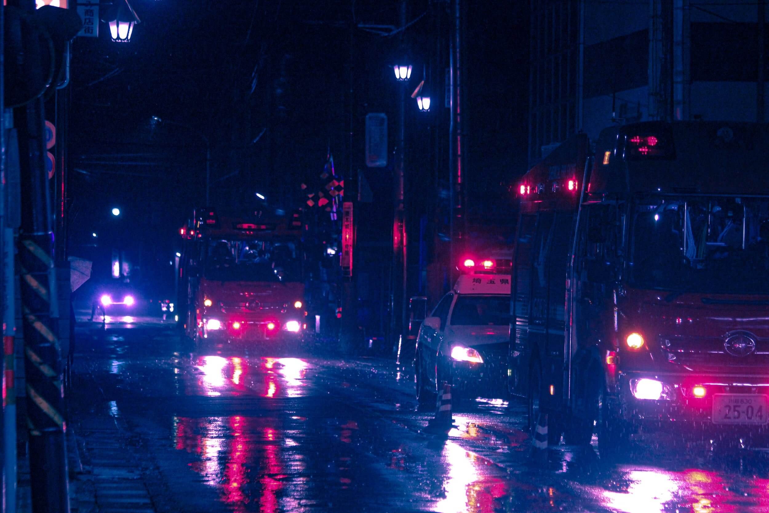 Emergency vehicles driving in the rain