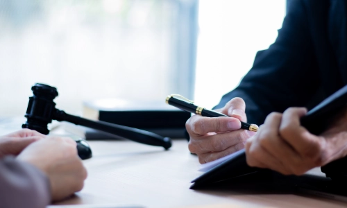 A train accident lawyer holding a clipboard with documents for a client to fill up for a claim.