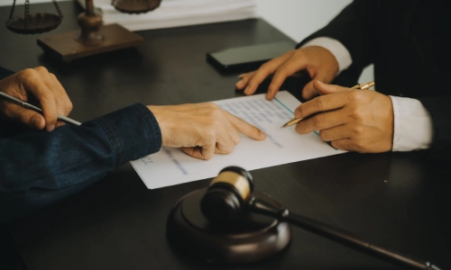 A workers' comp lawyer assisting a client with documents he is filing.