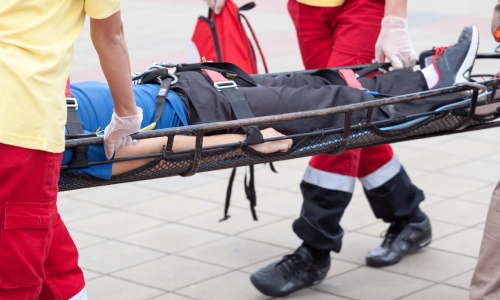 A group of paramedics transferring an injured man.